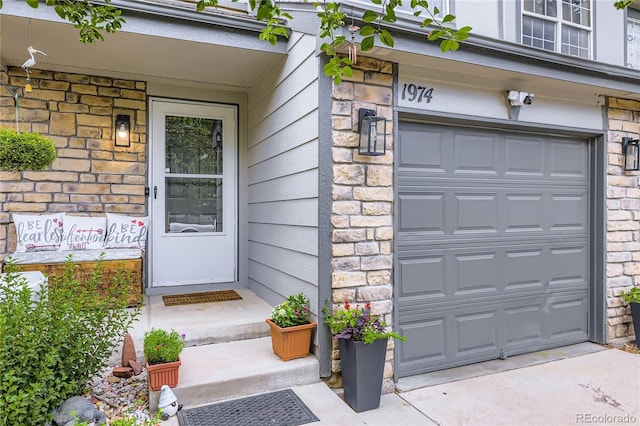 1974 E 102nd Cir, Thornton, CO 80229 - property entrance with stone siding and a garage