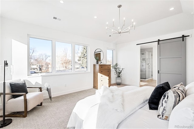 carpeted bedroom with a barn door, ensuite bathroom, and a notable chandelier