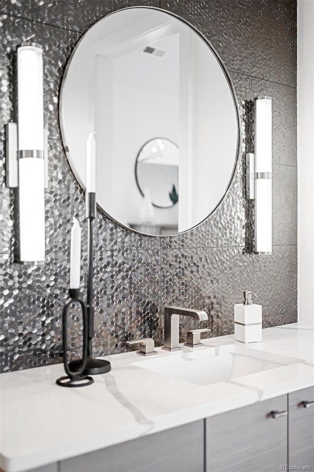 bathroom with decorative backsplash and vanity