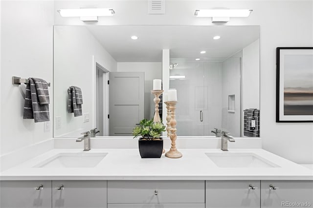 bathroom featuring vanity and a shower with door