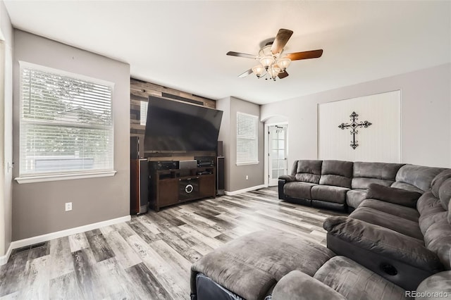 334 Octillo St, Brighton, CO 80601 - living room with a ceiling fan, wood finished floors, baseboards, and arched walkways