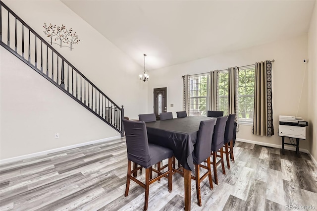 334 Octillo St, Brighton, CO 80601 - dining space with a chandelier, stairway, wood finished floors, baseboards, and lofted ceiling