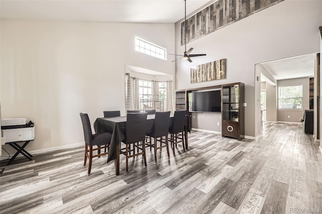 334 Octillo St, Brighton, CO 80601 - dining room with wood finished floors, baseboards, ceiling fan, and high vaulted ceiling
