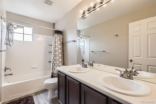 334 Octillo St, Brighton, CO 80601 - bathroom featuring shower / tub combo, toilet, double vanity, and wood finished floors
