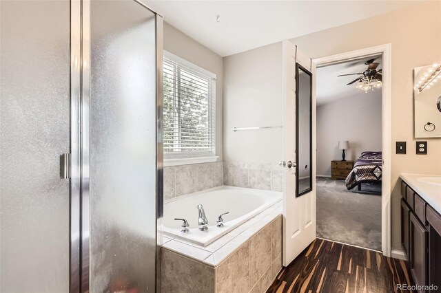 334 Octillo St, Brighton, CO 80601 - bathroom with vanity, a garden tub, a stall shower, wood finished floors, and connected bathroom