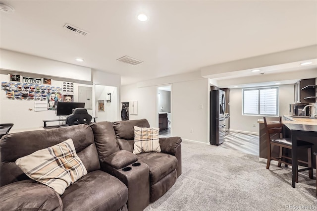 334 Octillo St, Brighton, CO 80601 - living area featuring light colored carpet, recessed lighting, and baseboards