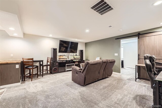 334 Octillo St, Brighton, CO 80601 - living area featuring recessed lighting, carpet floors, a barn door, and baseboards