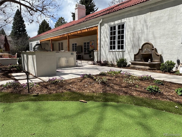 4 Cherry Hills Farm Dr, Cherry Hills Village, CO 80113 - back of house with exterior kitchen, a chimney, a patio area, stucco siding, and a tile roof