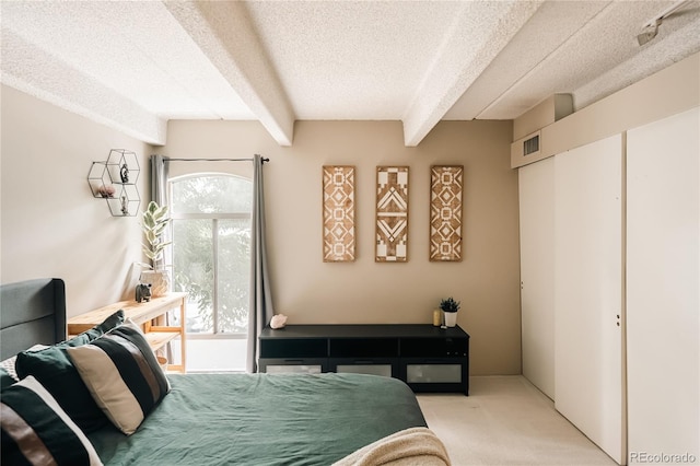 1365 Columbine St Unit 204, Denver, CO 80206 - bedroom with a textured ceiling, light colored carpet, and beamed ceiling