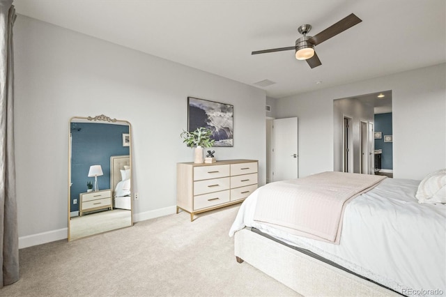 bedroom with light carpet, connected bathroom, and ceiling fan