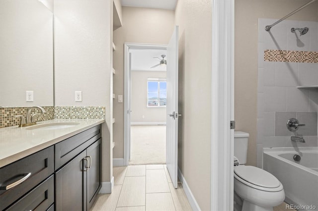 full bathroom featuring toilet, backsplash, vanity, and tiled shower / bath