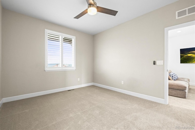 carpeted empty room featuring ceiling fan