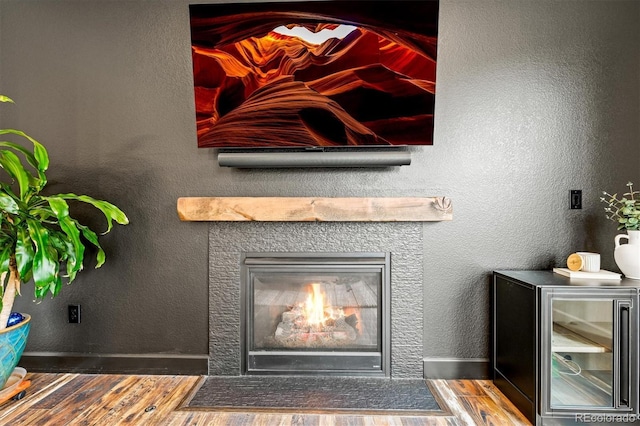 7875 S Grand Baker St, Aurora, CO 80016 - detailed view of wood finished floors and a fireplace with flush hearth