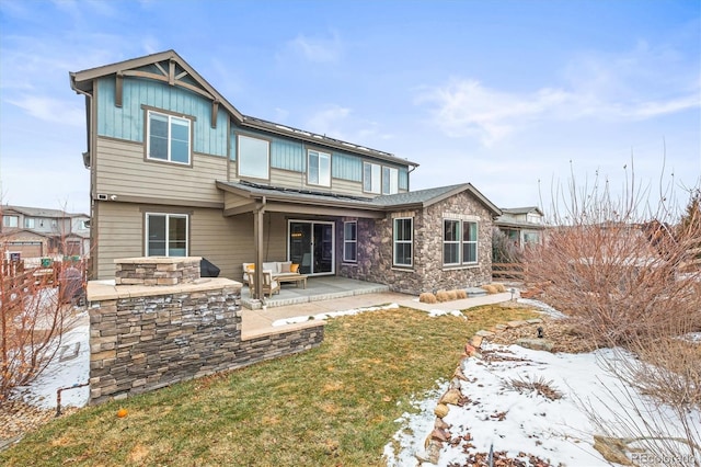 7875 S Grand Baker St, Aurora, CO 80016 - snow covered house with board and batten siding, stone siding, a patio area, and outdoor lounge area
