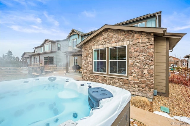 7875 S Grand Baker St, Aurora, CO 80016 - back of house with stone siding and a hot tub
