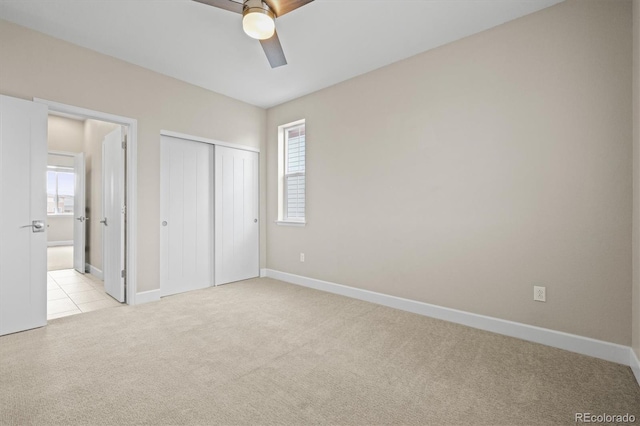 7875 S Grand Baker St, Aurora, CO 80016 - unfurnished bedroom with light carpet, multiple windows, a closet, and a ceiling fan