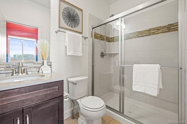 7875 S Grand Baker St, Aurora, CO 80016 - bathroom with vanity, a stall shower, wood finished floors, and backsplash