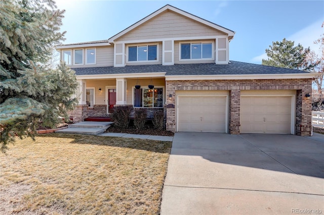 view of front facade with a porch, concrete driveway, a front yard, a shingled roof, and a garage