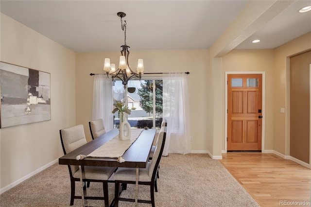 dining space featuring recessed lighting, baseboards, light wood finished floors, and a chandelier