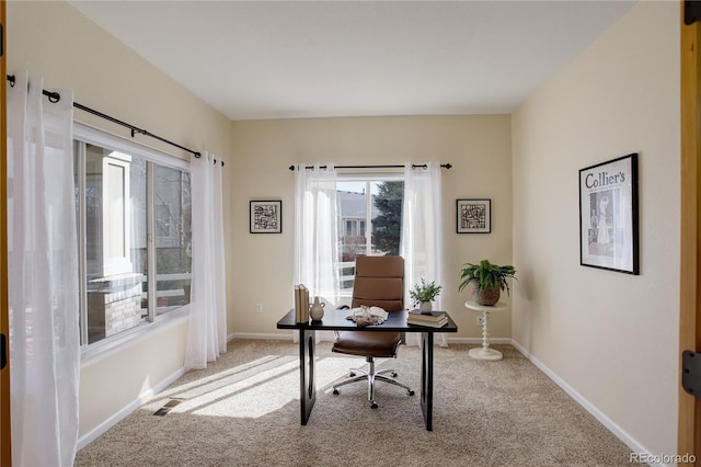 office with visible vents, light colored carpet, and baseboards