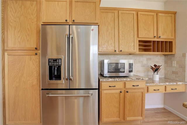 kitchen featuring light stone countertops, light wood-type flooring, decorative backsplash, stainless steel appliances, and open shelves