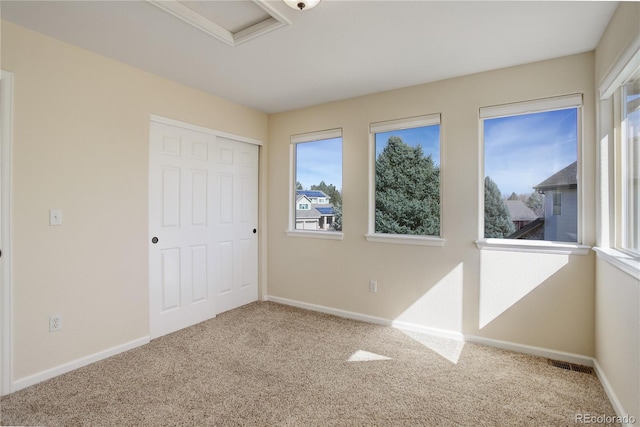 unfurnished bedroom featuring a closet, baseboards, visible vents, and carpet floors