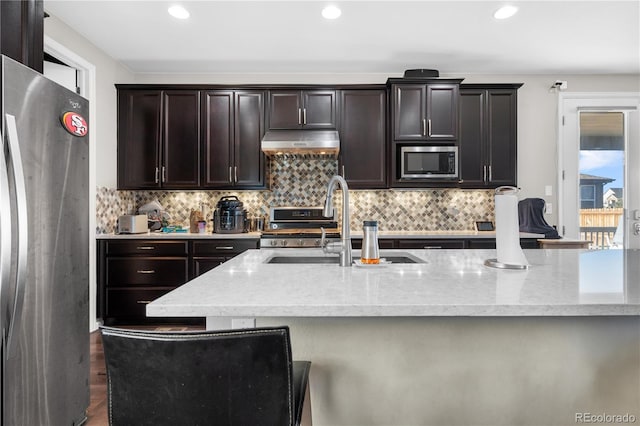 kitchen featuring dark brown cabinetry, decorative backsplash, sink, and stainless steel appliances