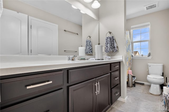 bathroom featuring tile patterned floors, vanity, and toilet