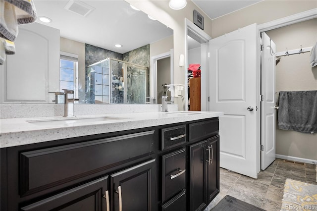 bathroom with vanity and an enclosed shower