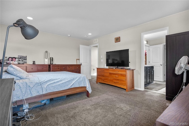 carpeted bedroom with connected bathroom