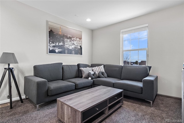 living room with dark colored carpet