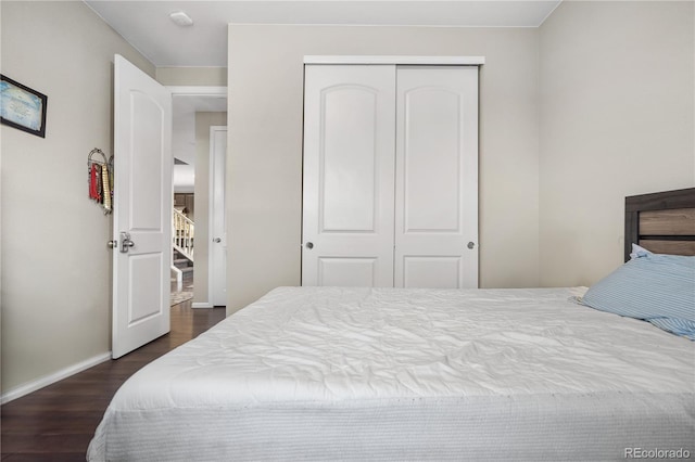 bedroom with a closet and dark wood-type flooring