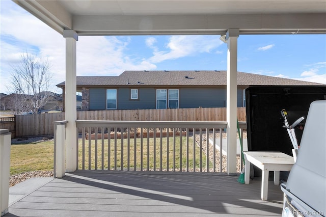 wooden terrace featuring a yard