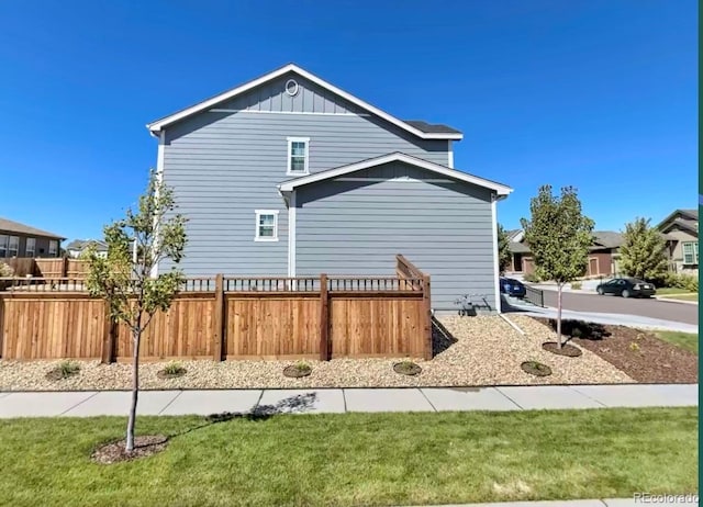 view of side of property with a yard