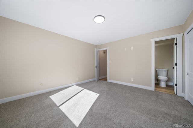 unfurnished bedroom with light colored carpet and ensuite bath