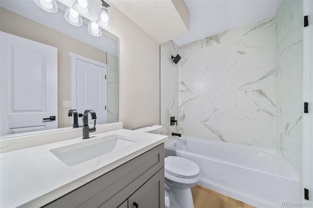 full bathroom featuring tiled shower / bath, vanity, toilet, and wood-type flooring