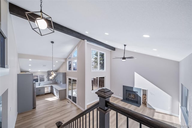 hallway featuring light hardwood / wood-style flooring, high vaulted ceiling, and beamed ceiling