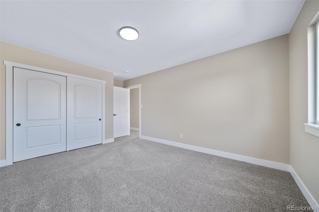 unfurnished bedroom with carpet floors and a closet