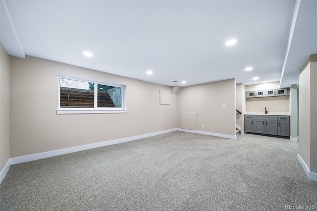 basement featuring light carpet