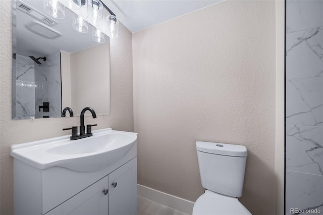 bathroom featuring vanity, toilet, and a shower