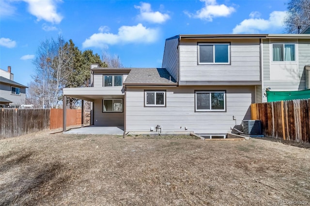 rear view of property featuring central AC unit and a patio area