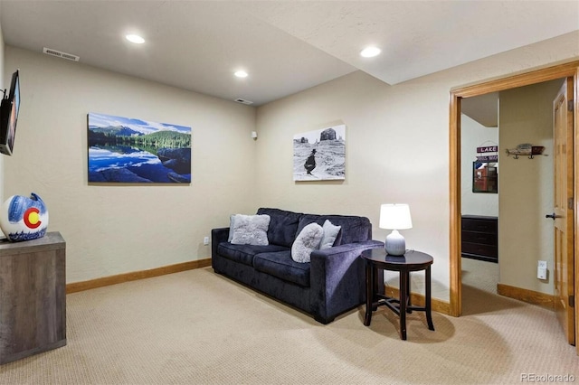 living area with carpet, visible vents, and baseboards