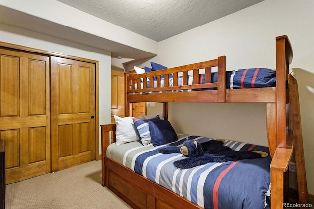 bedroom with light carpet and a textured ceiling