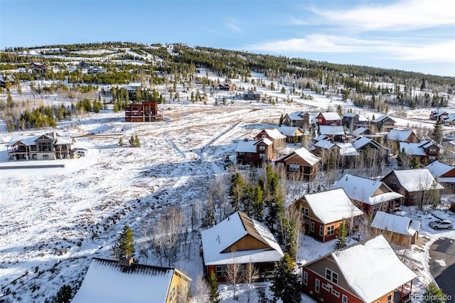 snowy aerial view with a residential view