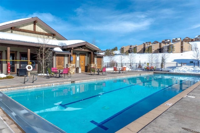 pool featuring fence and a patio