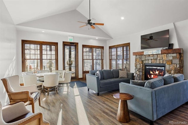 living room featuring ceiling fan, a stone fireplace, wood finished floors, and recessed lighting