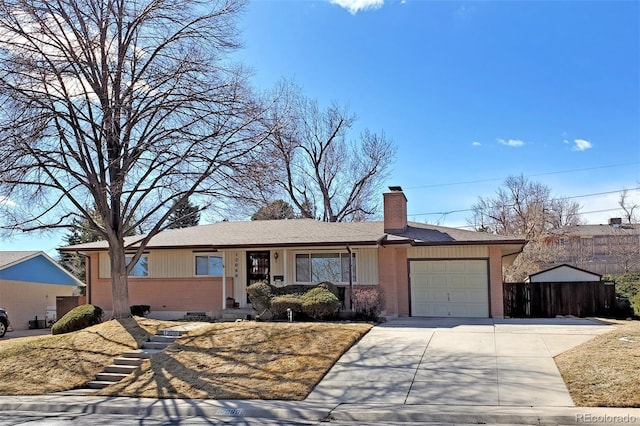 ranch-style house featuring driveway, a garage, a chimney, fence, and brick siding