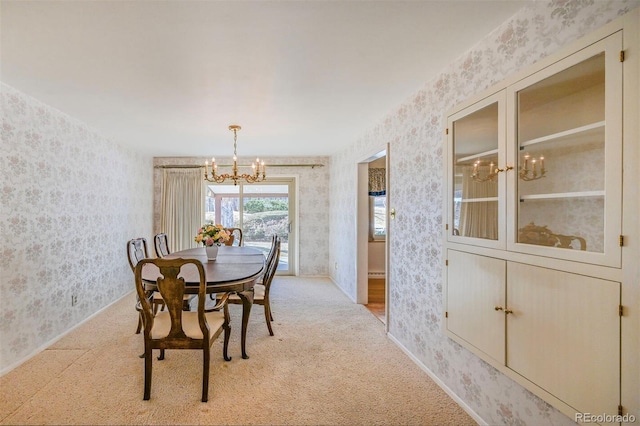 dining space with light carpet, an inviting chandelier, and wallpapered walls