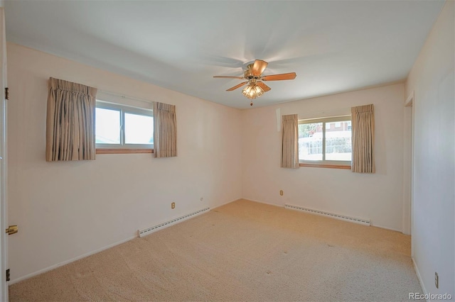 carpeted empty room featuring a baseboard radiator and a ceiling fan