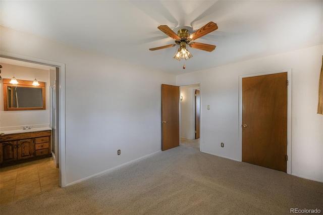 unfurnished bedroom featuring a ceiling fan, light carpet, and connected bathroom